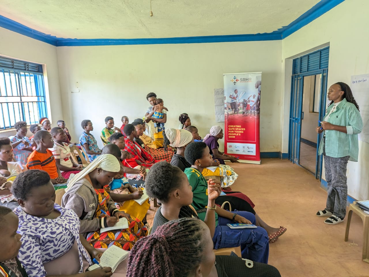 Christine Namusisi leading a financial literacy session with young mothers in Namayingo District.