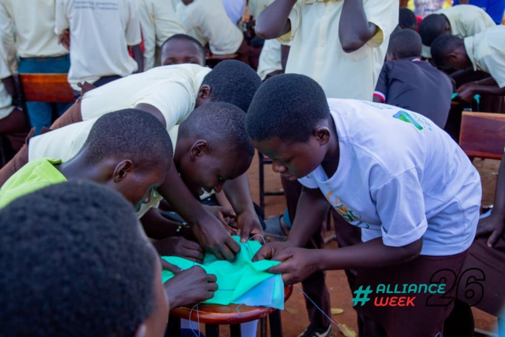 Boys join in learning how to make a reusable sanitary pad