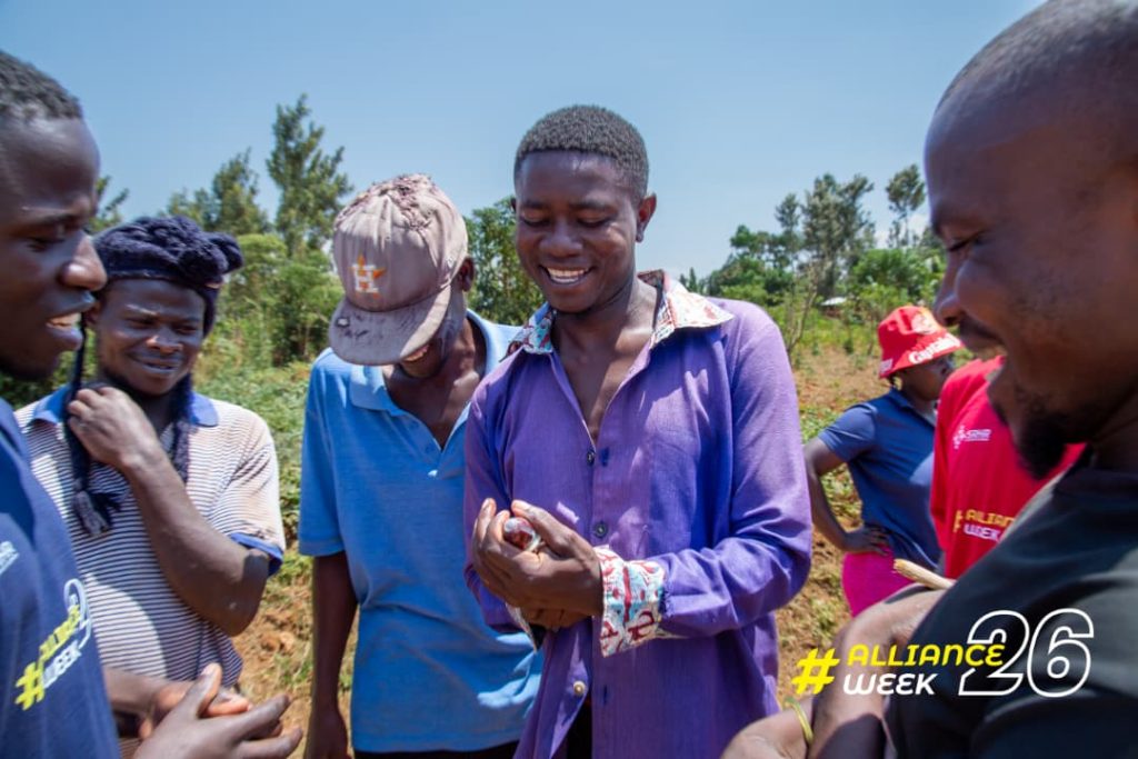 Young people being taught how to correctly use a condom