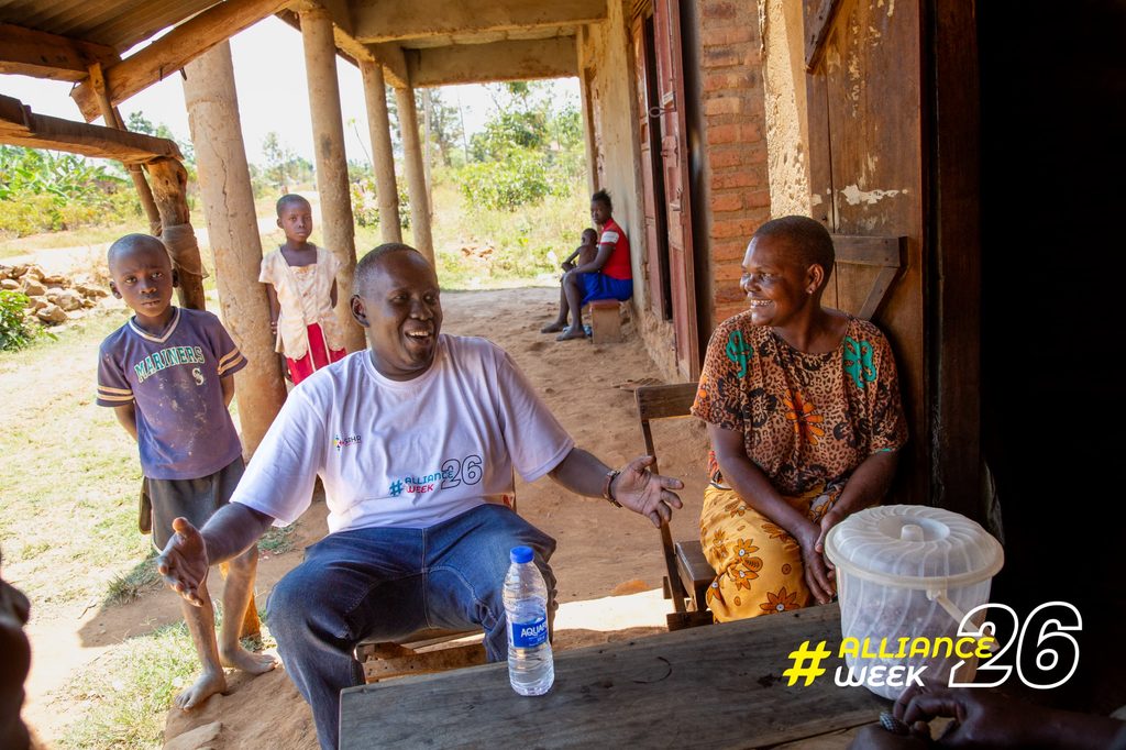 Sani Jerry shares a light moment with one of the residents of Bugana Sub-county, Namayingo District